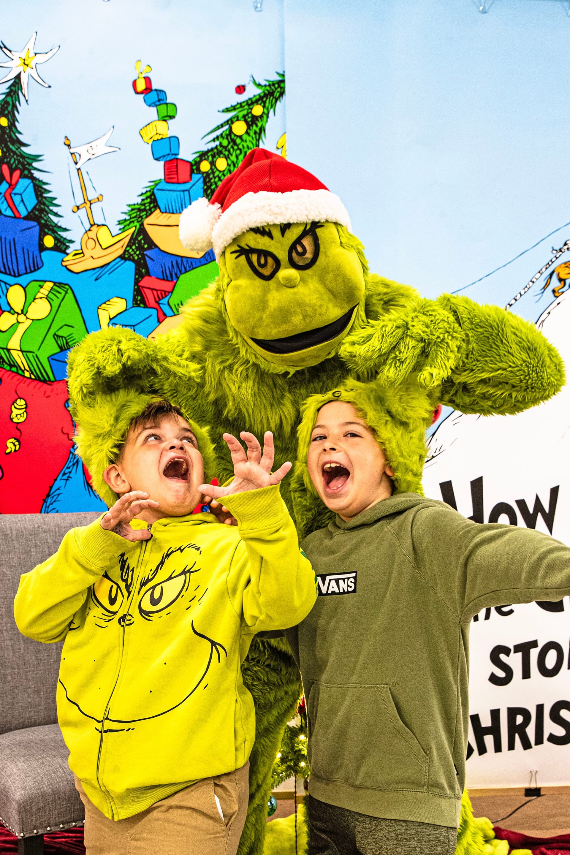 The Godwin brothers, Ayden, 7, and EJ, 9, pose for a photo with the Grinch inside Boscov’s department store during a Grinch event held in Christiana on Nov. 22, 2025.